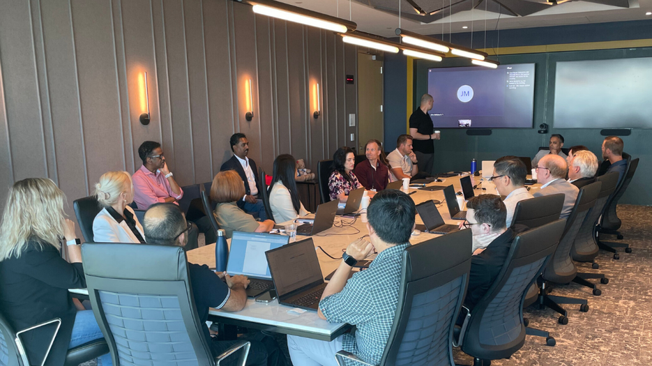 CFO AI EBS Event with executives gathered around a conference table during an AI leadership discussion