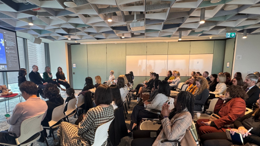 A room full of attendees engaged in a panel discussion at Empower Women at Microsoft Toronto