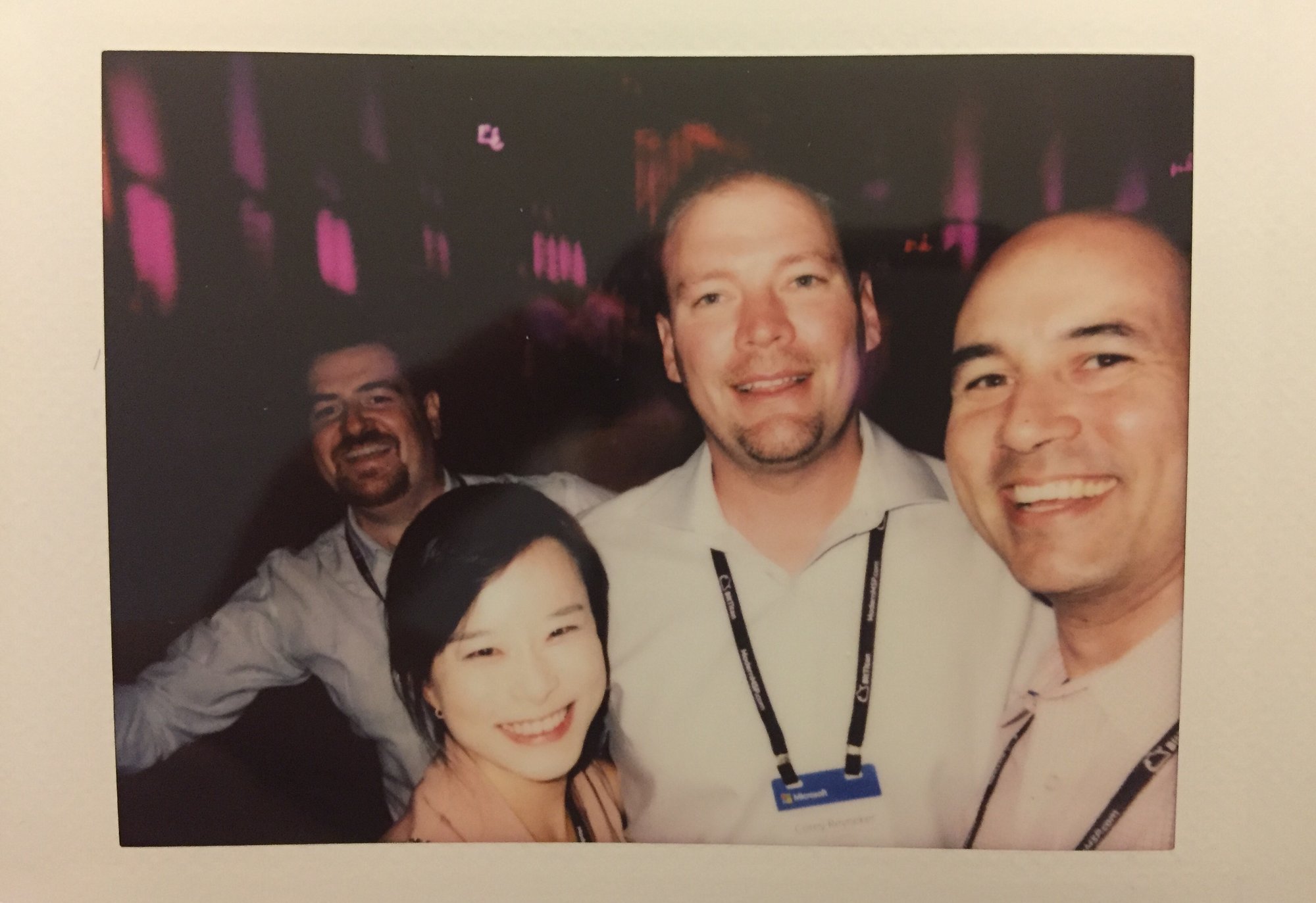 ProServeIT leadership team posing for a polaroid picture during a Microsoft event