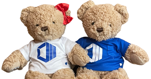Hope and Hugo, ProServeIT's brand ambassadors, two teddy bears wearing ProServeIT branded shirts, representing the warmth, care, and hospitality at the heart of everything ProServeIT does