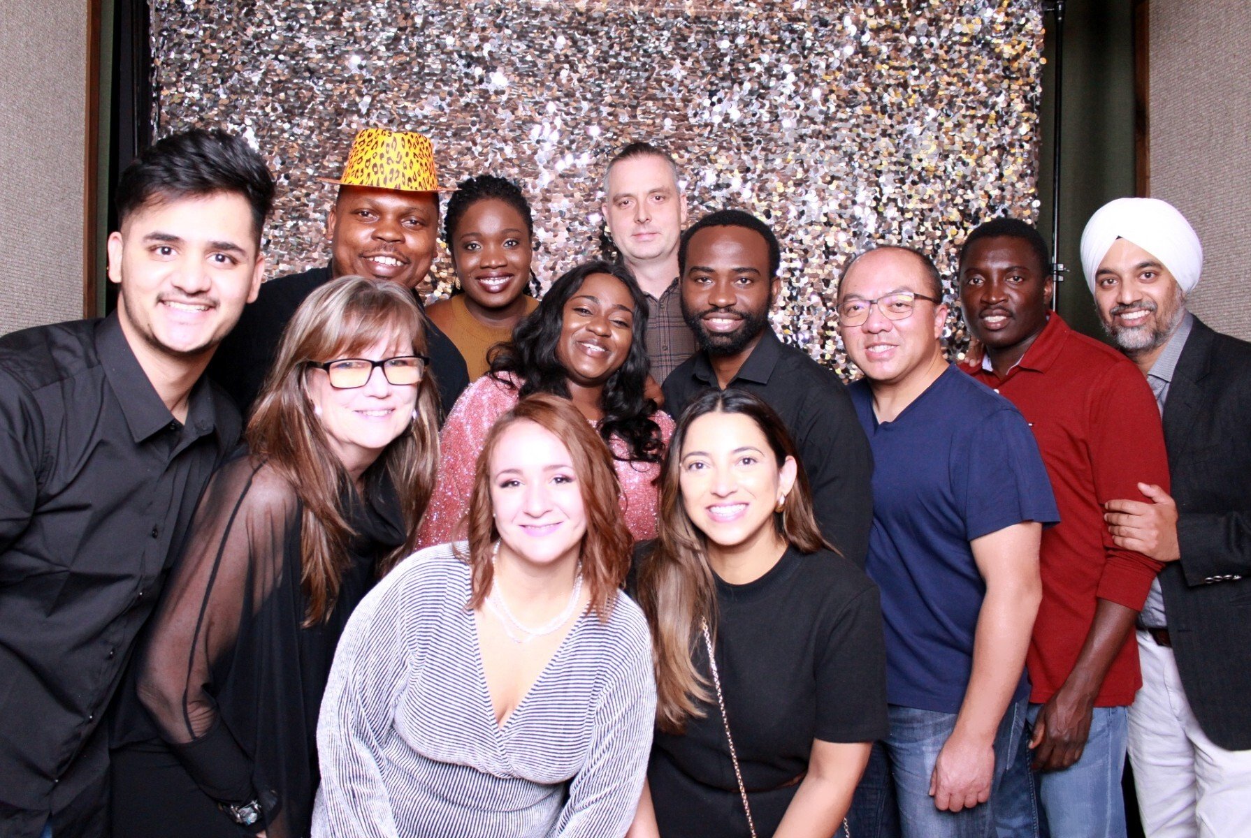 ProServeIT team members posing at a photo booth during a celebration of the company completing 20 years