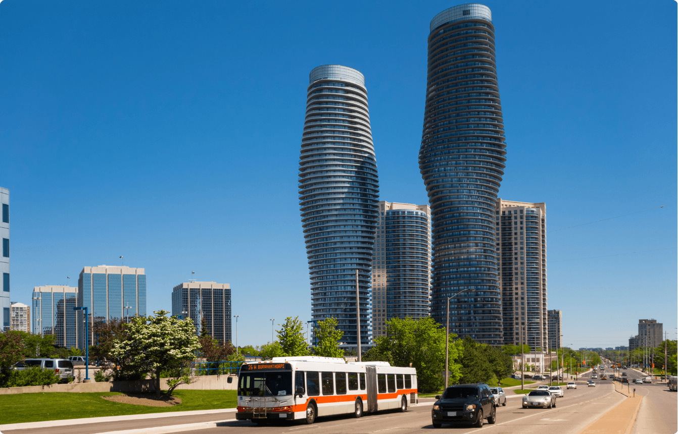 Mississauga skyline with the Marilyn Monroe Towers and surrounding high-rise buildings under a clear blue sky, representing the location of the AI Copilot EBS event.