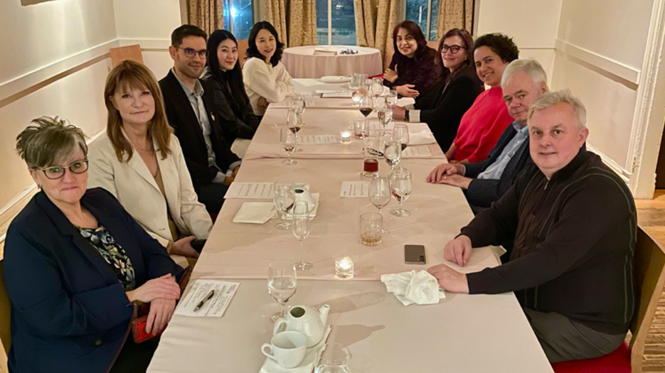 Salon Dinner - Calgary 2 - attendees seated together around a dining table during a salon-style networking dinner event