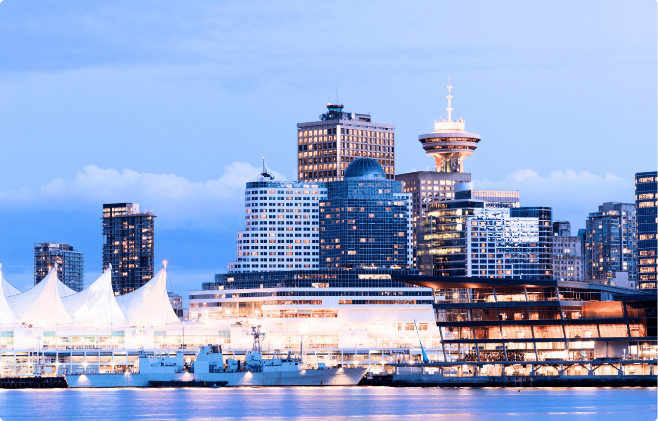Vancouver skyline with Canada Place and downtown waterfront buildings at dusk, representing the location of the AI Copilot EBS event.